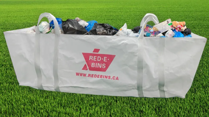 Red-E-Bins dumpster bag sitting in a driveway