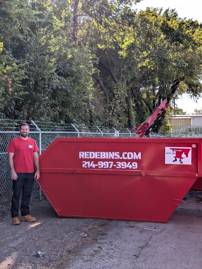 10-yard Red-E-Bins dumpster with a team member beside it